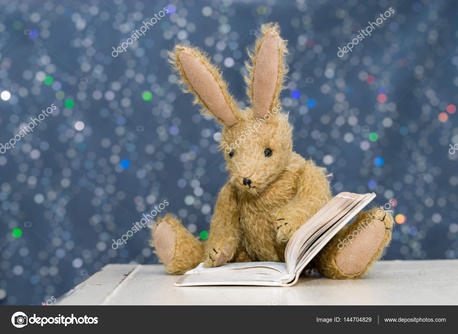 Cute child's toy rabbit reading at storytime. Stock Photo by ...