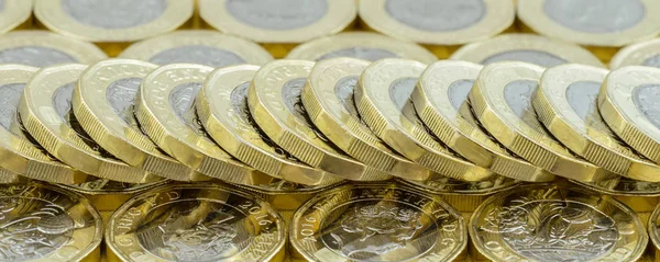 British money new pound coins spread out fallen stack