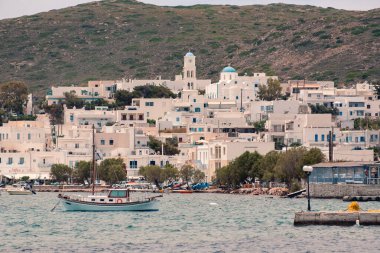 Yunanistan 'ın Milos kentindeki sahil ana limanı ve adaların yakınındaki güneşli havalara bak