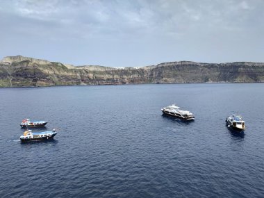 Santorini, Greece - April 28,2019: view on the cruise ships from top of the Thera city