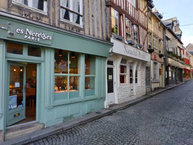 Honfleur, France - October 15, 2019: casual view on the city buildings and street life at sunny weather