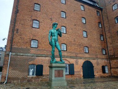 Casual view on sculptures of Copenhagen at cloudy weather in the old part of the city