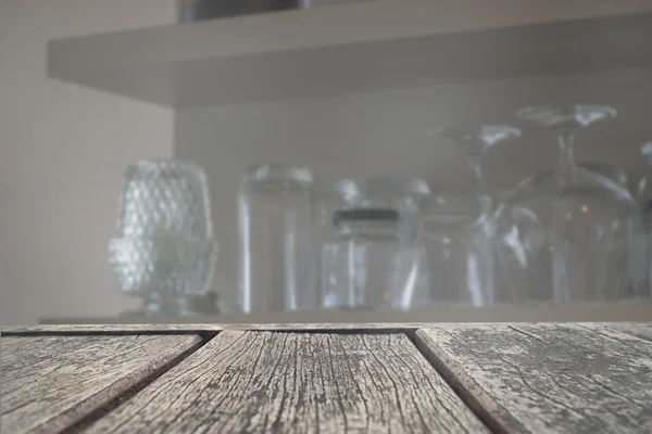 Wood table top on blur glass on shelf background — Stock Fotó