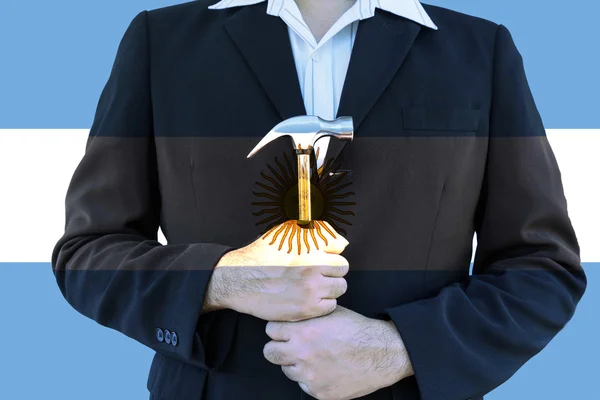 Argentina flag on business man hold hammer and wite and blue bak — Stock Photo, Image