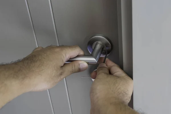 Locksmith repair silver knob on gray door — Stock Photo, Image