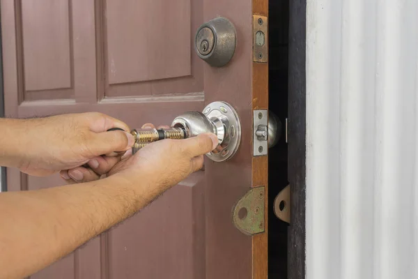 Locksmith use the cylider tool for open the door Stock Picture