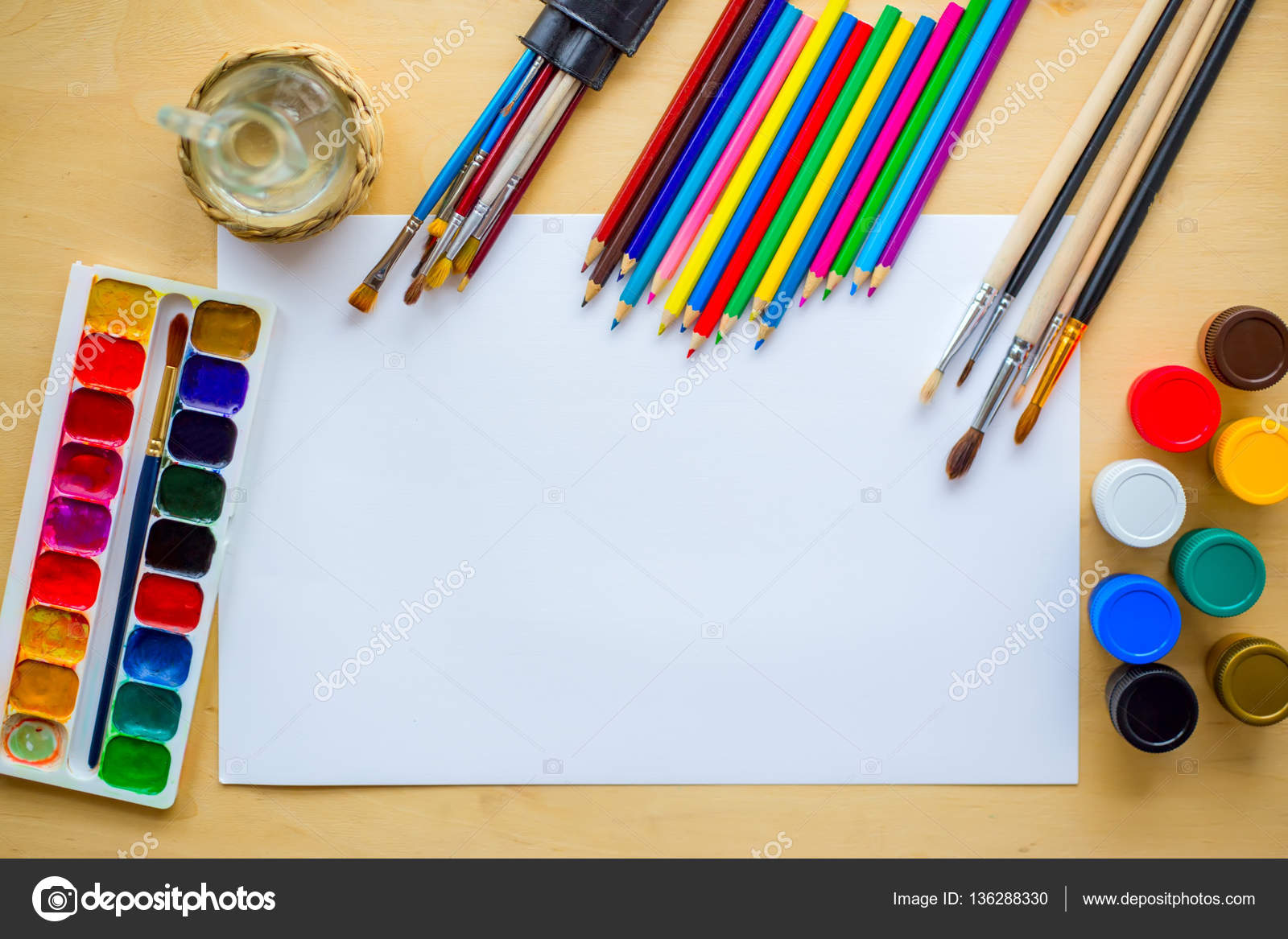 Drawing supplies brushes, pencil, aquarelle, gouache, paper on wooden  background Stock Photo by ©tatyun 136288330