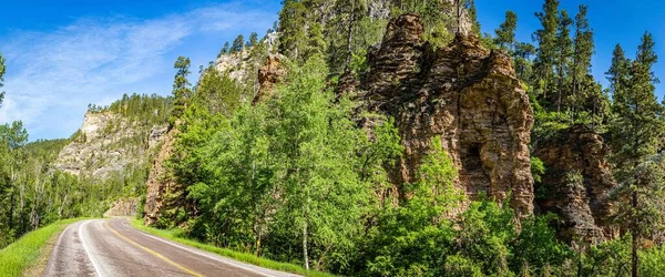 Spearfish Canyon Scenic Byway features thousand-foot-high limestone canyon walls in shades of brown, pink and gray along both sides of Highway 14A as it twists through the 19-mile gorge.