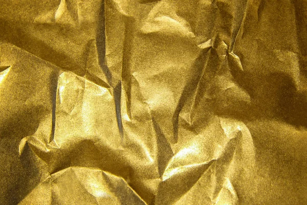 Золотий блискучий абстрактний металевий зім'ятий паперовий фон — стокове фото