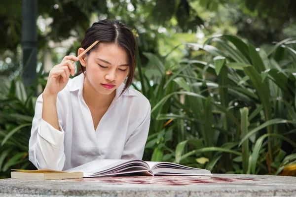 Asian woman working outdoor in the park Royalty Free Stock Photos