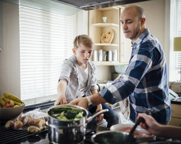Допомагаючи тато з приготування їжі — стокове фото