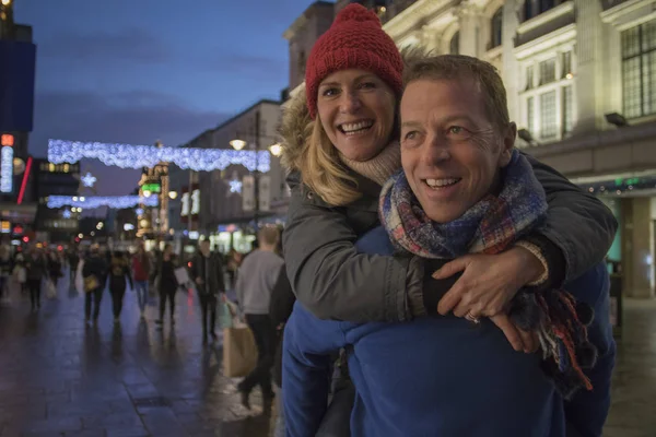 Piggy Back Through Festive City — Stock Photo, Image