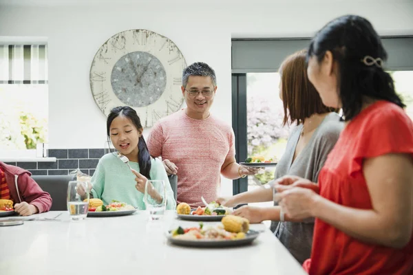 Three Generation Family Having Dinner