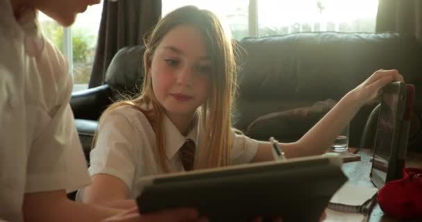 Little Girl Her Brother Doing Homework Together Using Digital Tablets — Stock Video