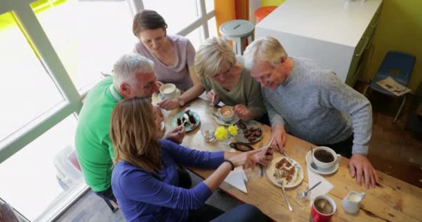 Directly Shot Group Five Mature Adults Sitting Talking Cafe Eating — Stock Video