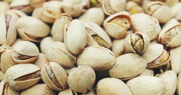 Dried roasted salted appetizing pistachios rotating — Stock Video
