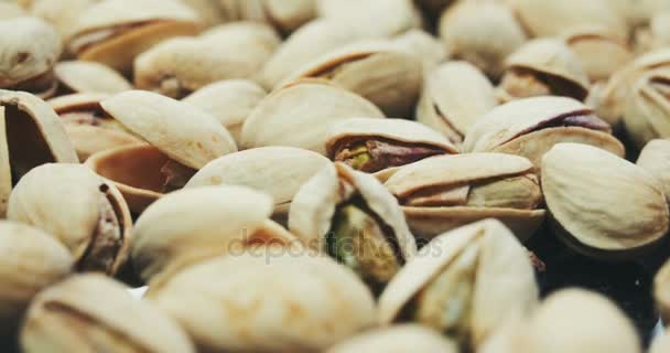 Dried roasted salted appetizing pistachios rotating — Stock Video