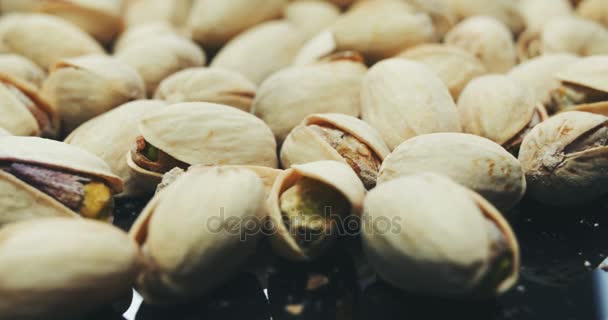 Dried roasted salted appetizing pistachios rotating — Stock Video