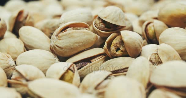 Dried roasted salted appetizing pistachios rotating — Stock Video