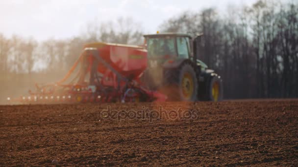 Agricultural tractor sowing and cultivating field — Stock Video