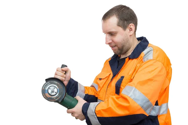 Man in overalls with a grinder — Stock Photo, Image