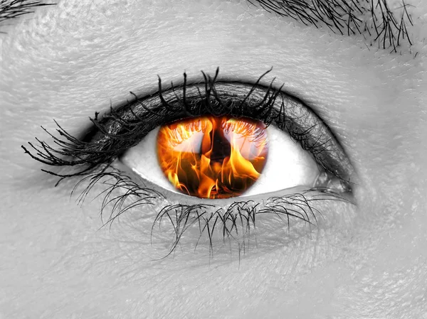 Closeup female eye iris burning
