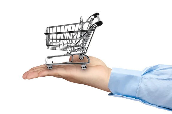 Big hand holding empty shopping cart — Stock Photo, Image