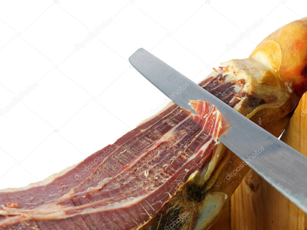 Knife slicing jamon or parma ham isolated on white