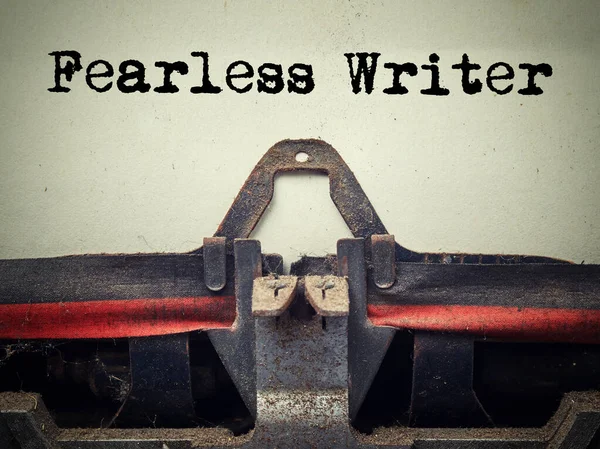 Close up of old typewriter covered with fearless writer dust with text — Stock Photo, Image