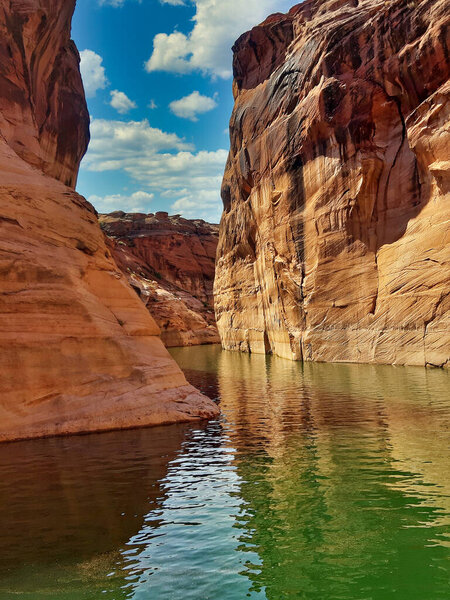 Beautiful canyon cliff-lined and lonely rocks from a boat in Glen Canyon National Recreation Area Lake Powell Arizona