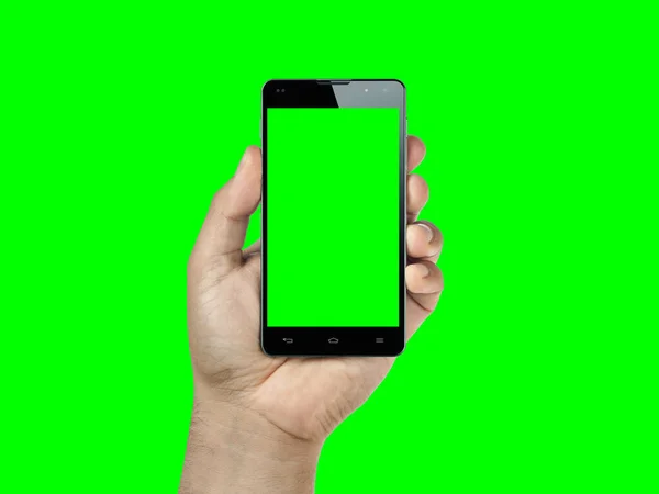 Крупним планом рука тримає і показує смартфон або мобільний з зеленим екраном ізольовані на зеленому — стокове фото