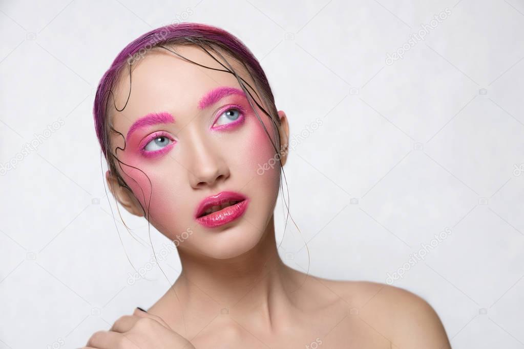 Woman with creative  pink colorful make-up