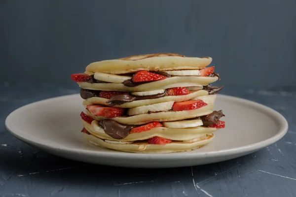 Deliciosas panquecas na mesa cinza com frutas . — Fotografia de Stock