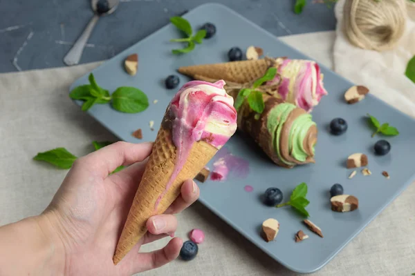 Ice cream cones on grey vintage background.