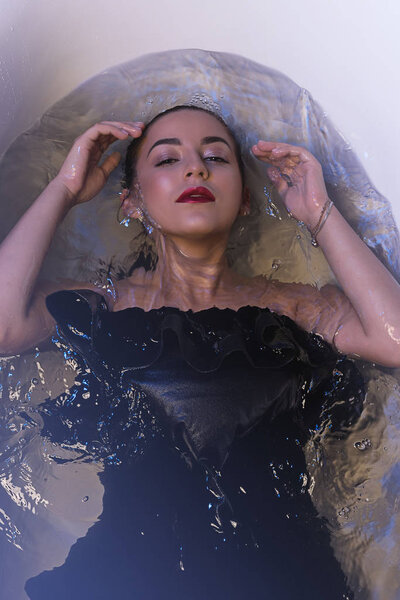 Fashion model girl taking a bath. 