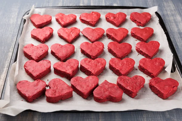 Red velvet heart cookies on baker paper.