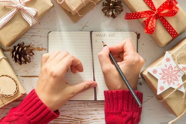 Making list of presents on wood background — Stock Photo, Image