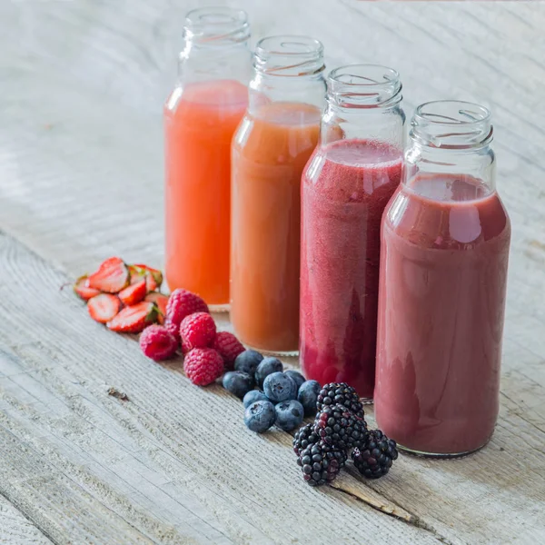 Selection of berry smoothies on rustic wood background — Stock Photo, Image