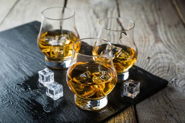 Whiskey with ice in glasses — Stock Photo, Image