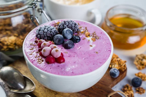 Breakfast - yogurt bowl with granola and berries, coffee, honey — Stock Photo, Image