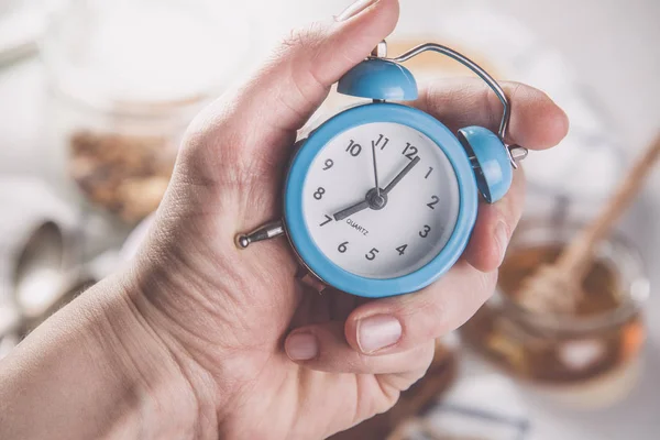 Morning alarm concept - hand with clock — Stock Photo, Image