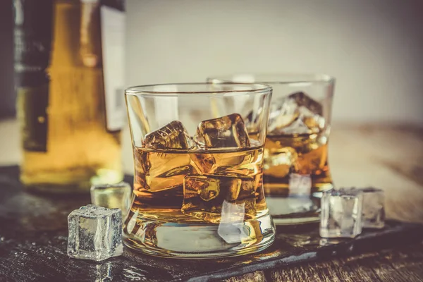 Whiskey with ice in glasses — Stock Photo, Image