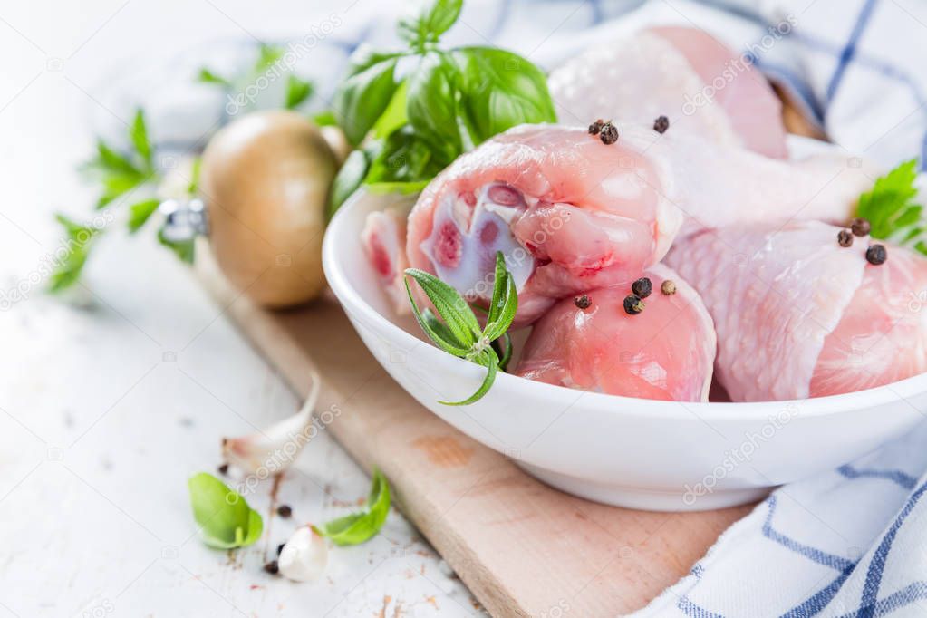 Raw chicken legs for bbc with herbs and spices