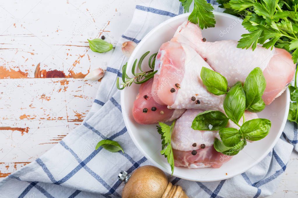 Raw chicken legs for bbc with herbs and spices
