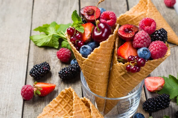 Selection of berries in ice cream cones - healthy dessert concept — Stock Photo, Image