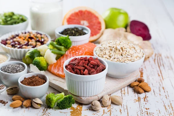 Selection of superfoods on rustic background — Stock Photo, Image