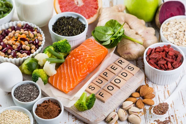 Selection of superfoods on rustic background — Stock Photo, Image