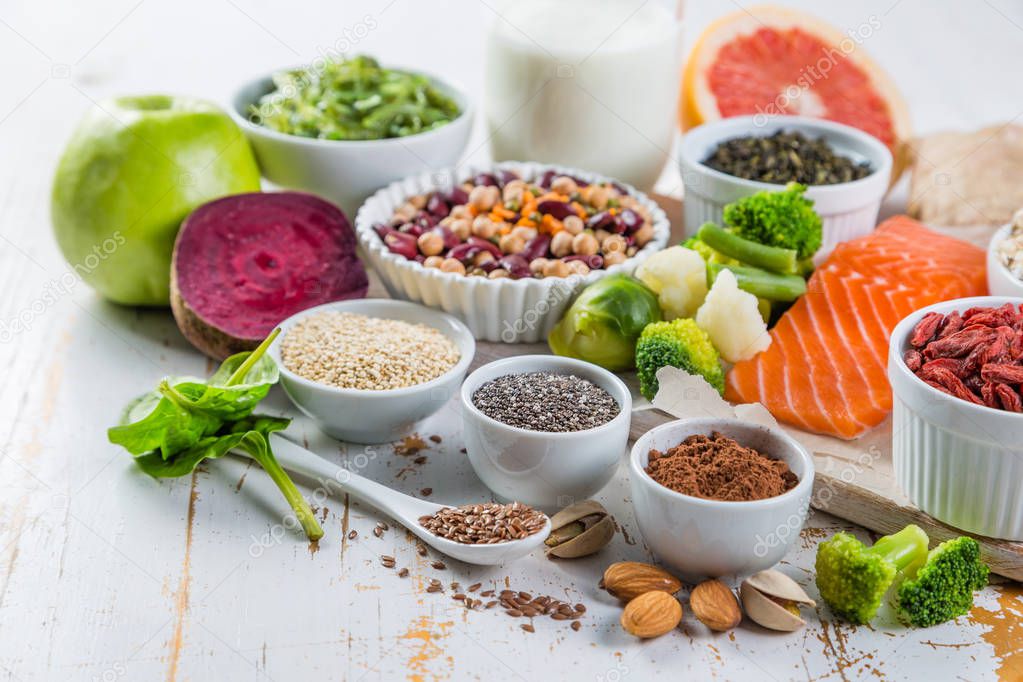 Selection of superfoods on rustic background