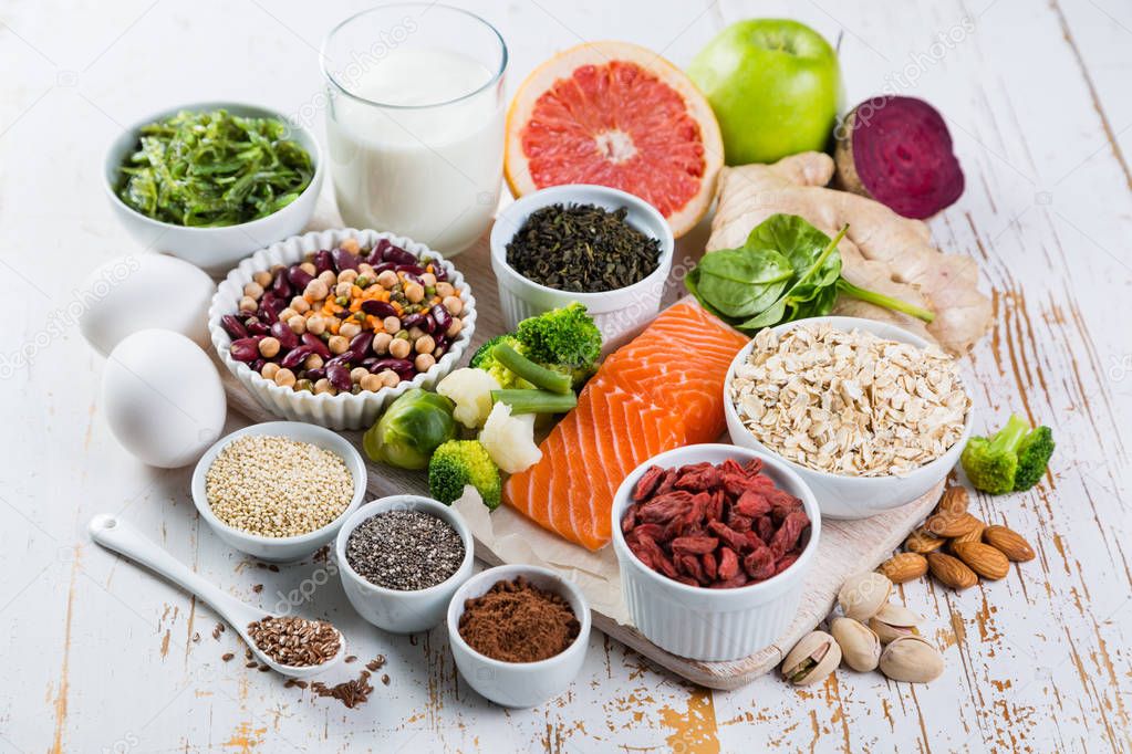 Selection of superfoods on rustic background