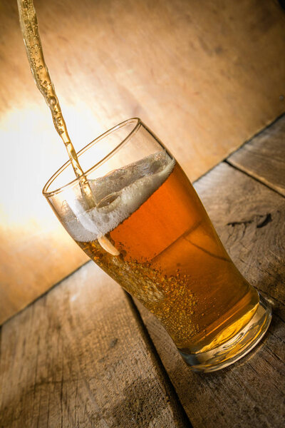 Beer in frosty mugs on rustic background